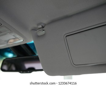 Closeup Of Sun Visor With Mirror In Car.