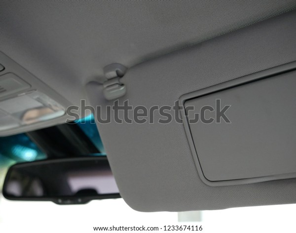 closeup of sun visor\
with mirror in car.
