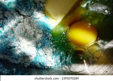 A Close-up Of Sunlight Shining On Blue Velvet Cake Mix With An Egg In It