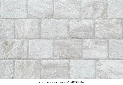 Closeup surface brick pattern at old gray stone brick wall texture background at the fence of house