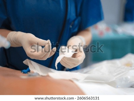 Close-up of surgeon's hands preparing gauze, highlighting sterile procedure and wound care during medical operation