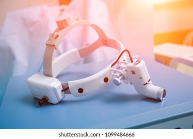 Close-up of surgeons medical headlight. Background - Powered by Shutterstock