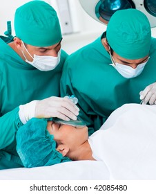 Close-up Of Surgeons Near Patient Lying On Operating Table In The Hospital. Healthcare Workers In The Coronavirus Covid19 Pandemic
