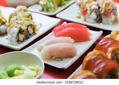 A Closeup Of Sushi With Various Rolls, Yellowtail Nigiri, Tuna Nigiri, Wasabi, Edamame 