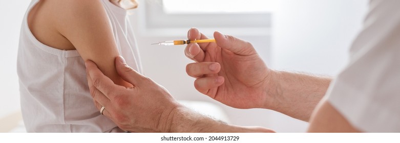 Close-up Of A Sweet Blond Boy And A Doctor With A Syringe