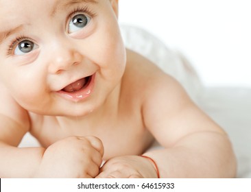 Close-up Of Sweet Little Baby Face, Smiling And Looking Up, Copyspace