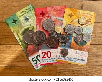 Closeup of Swiss national currency. Swiss coins and banknotes on a parquet floor. Swiss francs