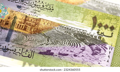 A close-up of a Syrian 1000 Pound banknote reveals intricate art and design. Amidst the country's turmoil, it showcases historical landmarks, symbolizing resilience and hope for a brighter future - Powered by Shutterstock