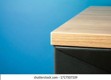 Close-up Of A Table Corner Solid Wood Furniture Detail With Blue Background