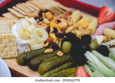 Closeup Of A Table With Pickles, Celery, Strawberries, Olives, Cheese, Hearts Of Palm, Cookies, Nuts And Ham