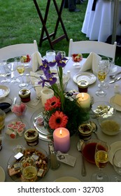 A closeup of a table setting at an outdoor wedding reception.