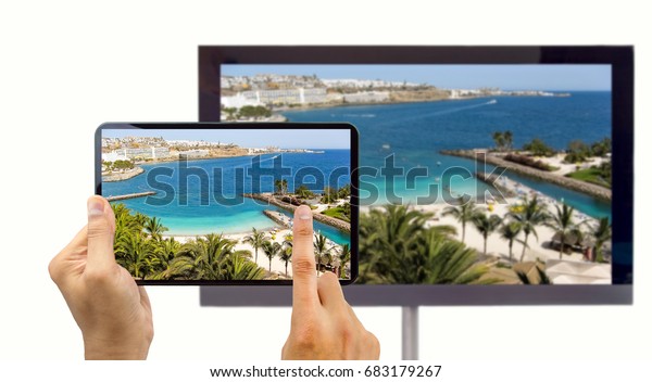 closeup of a tablet\
connected to a smart tv and envisioning photos in networking (tv\
and telephone image from a photo of a beach canary island is from\
my portfolio)
