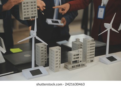 Close-up at tablet, Engineers pointing at tablet with their hands. To jointly design the use of renewable energy with wind and solar energy. Concept of using renewable energy.
