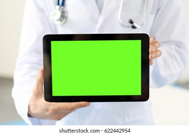 A close-up tablet with green screen