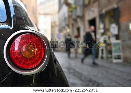 Close-up of taillight, modern car at city street, Rome, Italy