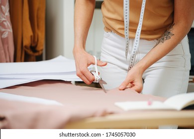 Close-up Of The Tailor Hands With Scissors, Making A Cut Of The Fabric