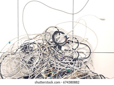 Closeup Of Tangled Computer Wires On Tiled Floor In Office