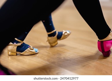 Close-Up of Tap Dance Shoes on Wooden Floor in Dance Studio - Powered by Shutterstock