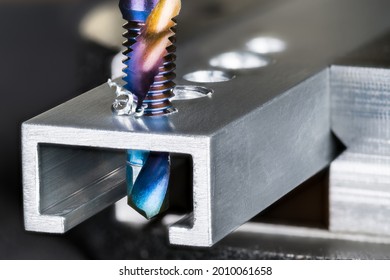 Closeup Of Tap And Drill Bit Making A Threaded Hole In Aluminum Profile With Metal Shavings. Spiral Twisted Nano Titanium Coated Product 2 In 1. Professional Drilling And Tapping Tool. Chip Machining.