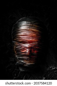 A Closeup Of The Taped Mummy Face With The Black Background