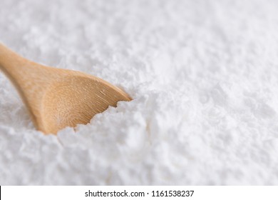 Close-up Of Tapioca Starch Or Flour Powder In Wooden Spoon With Wooden Background