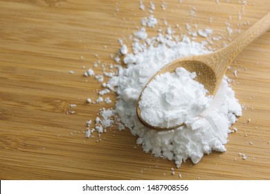 Close-up Of Tapioca Starch Or Flour Powder In Wooden Spoon With Wooden Background