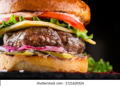 Close-up Tasty burger with beef, tomato, pickled, onion, lettuce and sauce - Powered by Shutterstock