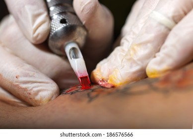 The Close-up Of A Tattooing Needle During The Tattoo