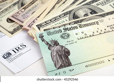 Close-up of tax return check and USA currency