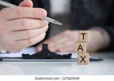 Close-up Of Tax Word Collected Of Wooden Blocks Letters In Row. Government, State Taxes, Calculation Individual Income And Tax Laws Concept