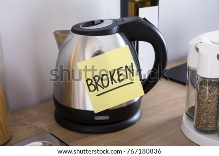 Close-up Of A Tea Flask With Adhesive Notes Showing Broken Text