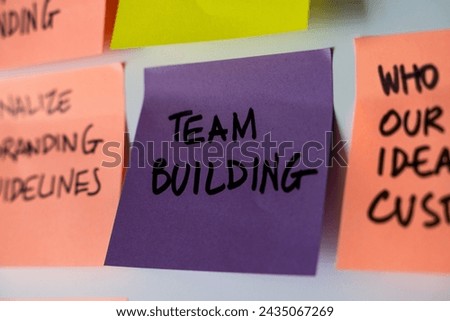 Close-up of a 'TEAM BUILDING' sticky note - Emphasis on workplace synergy and staff development - A visual cue for corporate training strategies