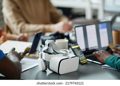 Close-up of team of programmers testing new interface of virtual reality glasses in teamwork