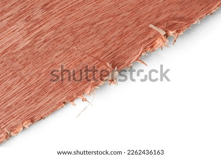 close-up of tear out and splinters on plywood, rough, jagged edges resulted from cutting with a wrong blade, isolated on white background, unprofessional construction concept with copy space