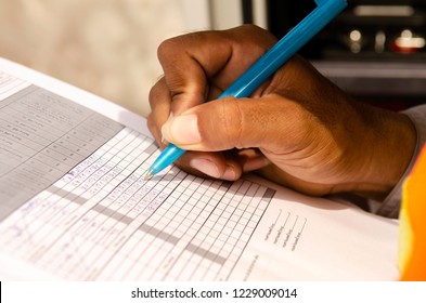 close-up of technician fill the maintenance form,Engineer write data in maintenance check list. writing a technical report about the manufacturing process - Powered by Shutterstock