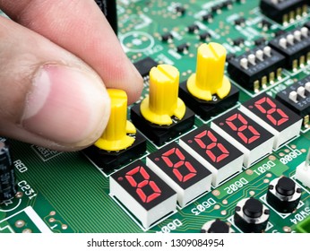 Closeup of a technician's hands checking electronic PCB (Printed circuit board) with microchips processor technology.