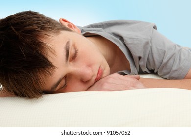 Closeup Of A Teen Boy Sleeping On A Bed