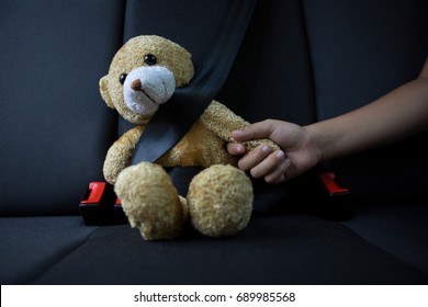 Close-up of teenage girl sitting with teddy bear in the back seat of car - Powered by Shutterstock