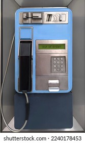 close-up of a telephone booth that is out of service. the booth is clean and the phrase out of service can be seen on the screen.