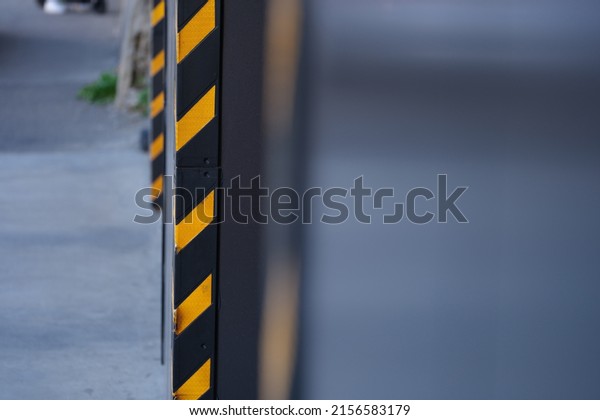 Close-up of temporary\
construction sign, warning workers or size limiter. Yellow with\
black sticker or tape