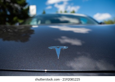 Close-up Of A Tesla Icon On The Hood Of A Black Car. 