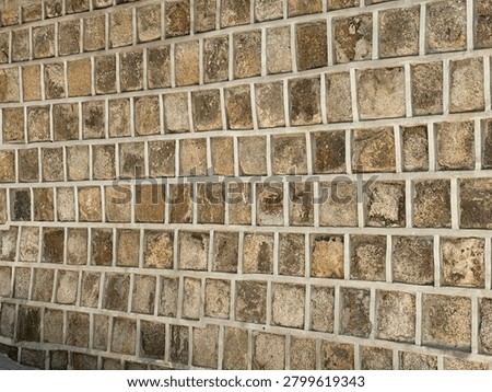 Close-up texture of ancient stone wall in Seoul, South Korea, showing rough, irregular light brown and beige stone blocks typical of historic Seoul city walls and palace fortresses. A detail of traditional Korean masonry and architecture from the Joseon Dynasty period. Perfect for architecture, history, texture, and Korea concepts.