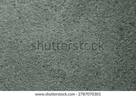 Close-up texture of asphalt surface with abstract natural pattern and monochrome tone.
