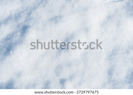 A close-up texture of falling snow, each flake distinct and beautiful. Abstract winter background