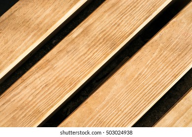 Closeup Texture Fragment Of The Wooden Bench In The Park In Fall,top View, Diagonal Lines Of Light And Shadow, High Contrast