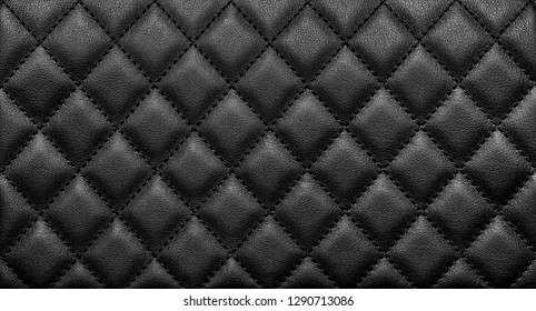 Close-up texture of genuine leather with black rhombic stitching. Luxury background