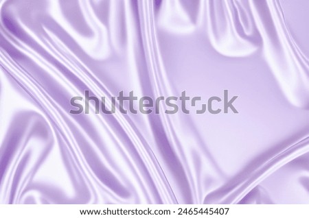 Close-up texture of light purple silk. Light purple fabric smooth texture surface background. Smooth elegant violet silk in Sepia toned. Texture, background.jpgClose-up texture of light purple silk. L