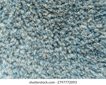 Close-up texture of mosque carpet surface with detailed fabric pattern and fibers.