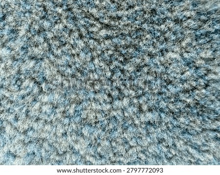 Close-up texture of mosque carpet surface with detailed fabric pattern and fibers.