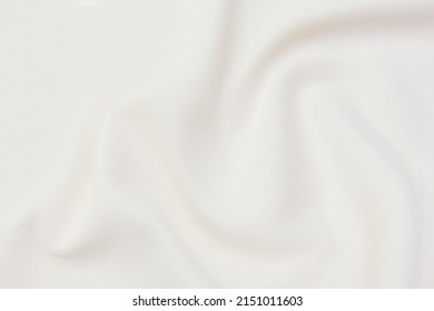 Close-up texture of natural beige or ivory fabric or cloth in brown color. Fabric texture of natural cotton or linen textile material. Beige canvas background.